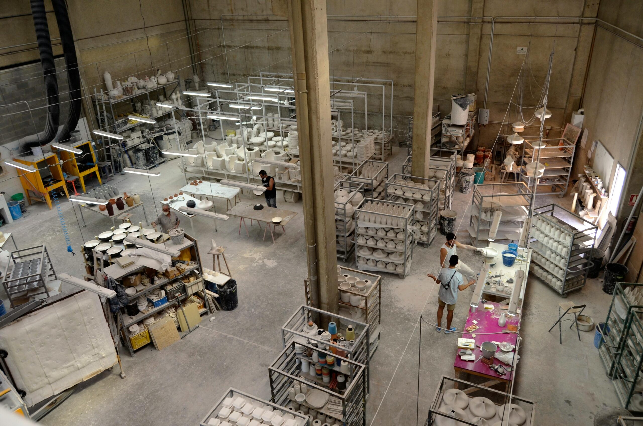 Aerial view of a pottery workshop with people crafting ceramics in Barcelona.